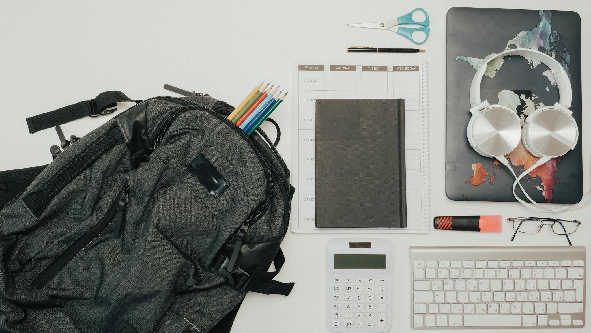 A flat lay of a clean and organized workspace with various office supplies.